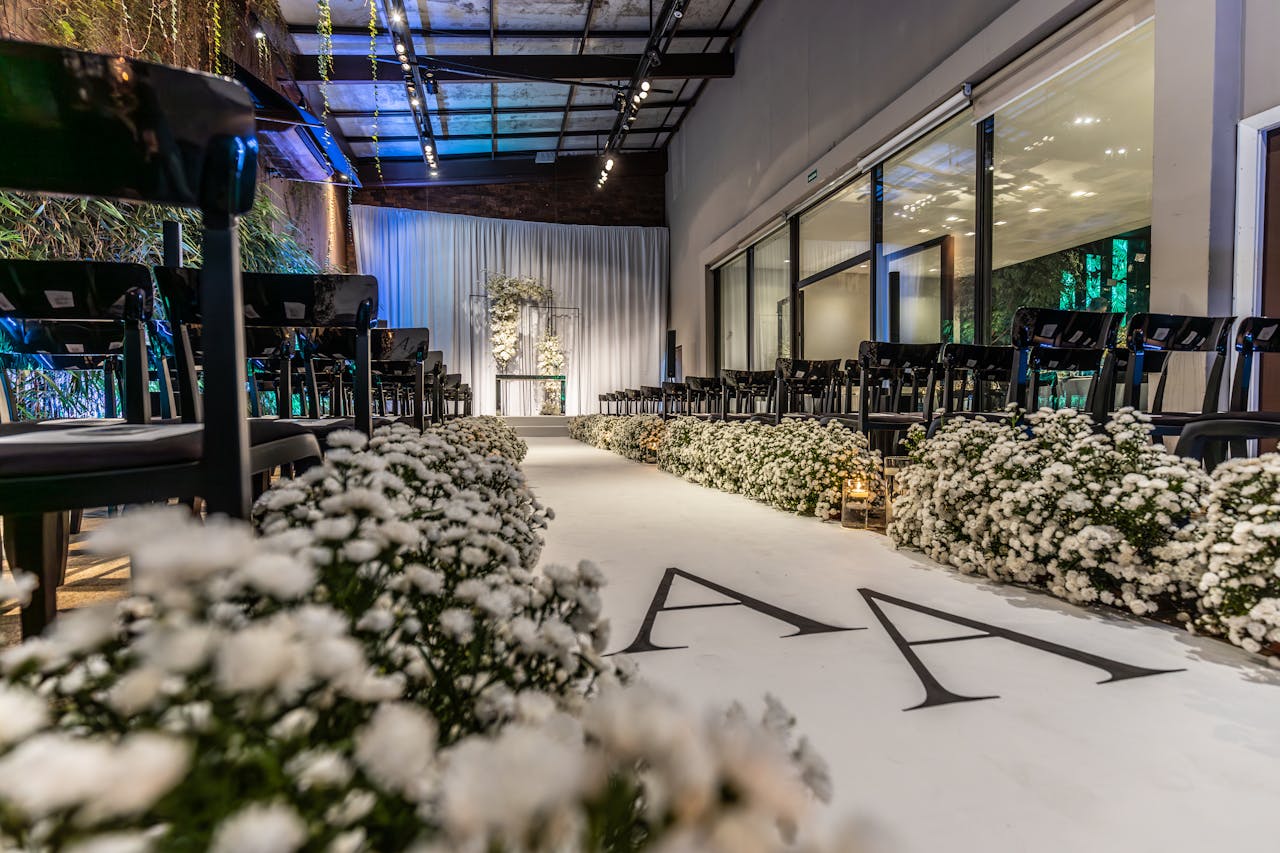 testimonial-img Beautifully decorated indoor wedding venue with white florals and elegant seating arrangement.