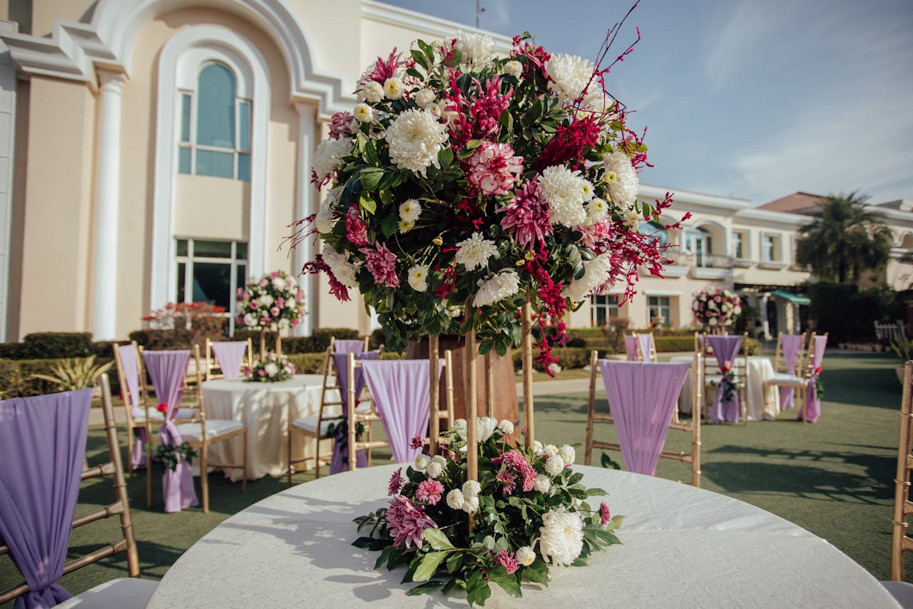why-choose-us-02 Beautifully decorated outdoor wedding reception with floral centerpieces and elegant seating.