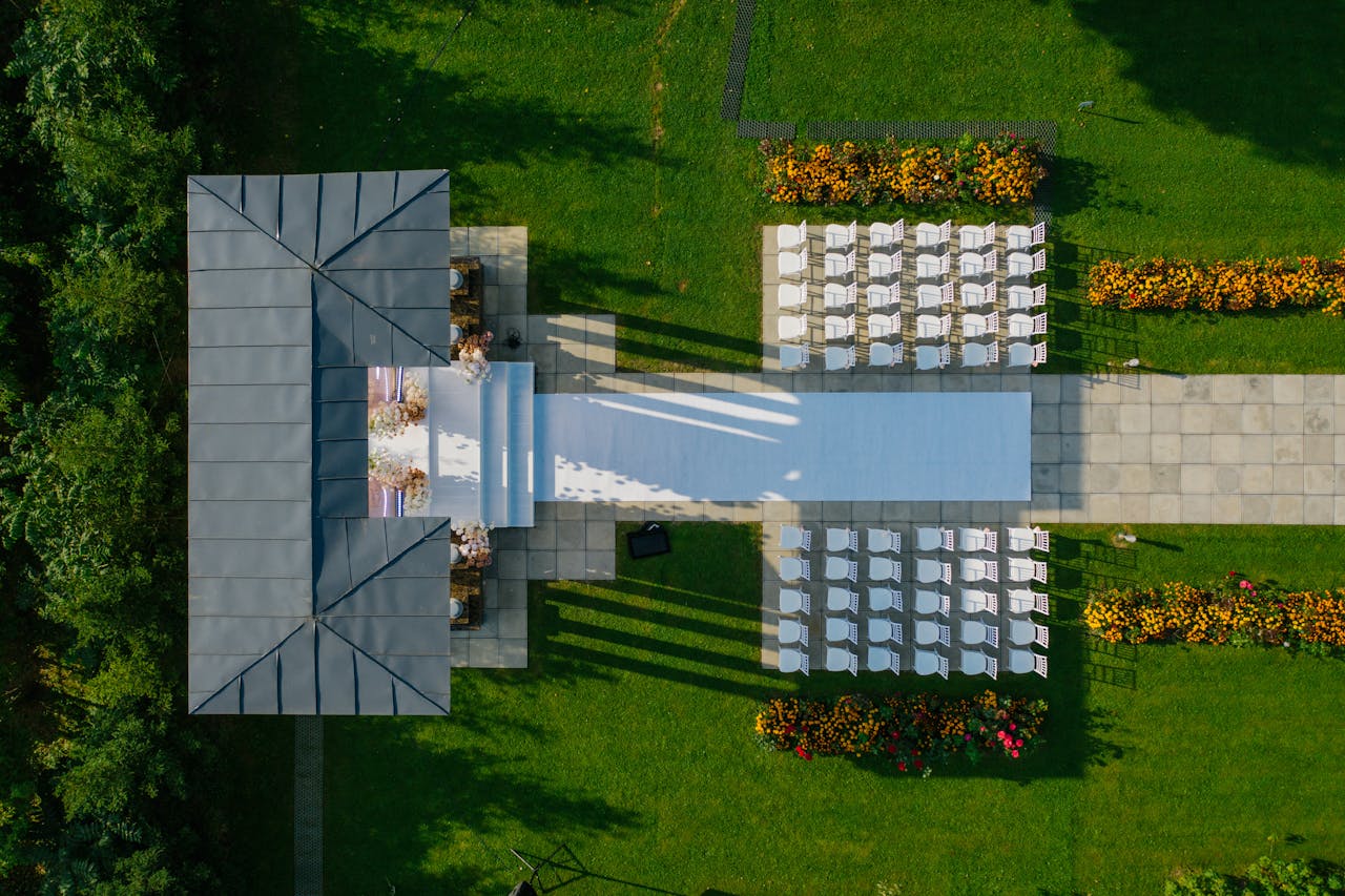 about-01 Drone shot of beautifully prepared outdoor wedding venue with chairs and gazebo.
